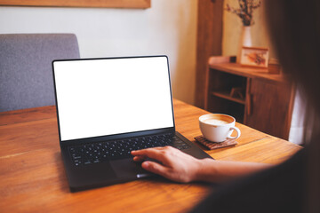 Mockup image of a woman using and touching on computer laptop touchpad with blank desktop screen at home