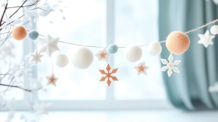 A whimsical garland with a mix of felt snowflakes, paper stars, and pom poms, strung with twine and hung across a window.