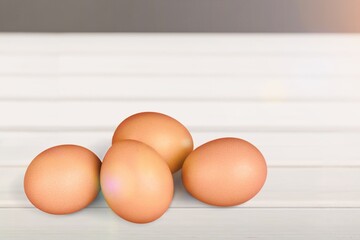 Stack of fresh tasty chicken egg on desk