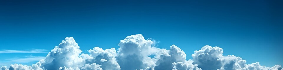 A clear blue sky with fluffy white clouds, creating a serene and peaceful atmosphere.