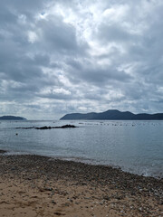 It is a beach with pebbles and sand.