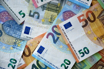 Many european euro money bills in chaotic arrangement. Pile of eur banknotes with different colors and condition