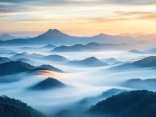 Obraz premium A breathtaking landscape of majestic mountain peaks emerging above a sea of clouds at sunrise, with soft light illuminating the scene.