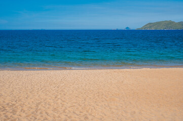 view of the sandy beach of Nha Trang and the sea on a sunny day