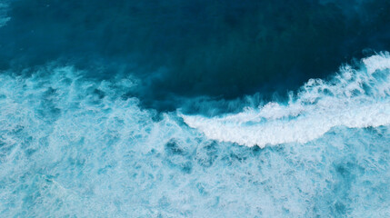 Turquoise ocean sea water white wave splashing deep blue sea. Bird eye view monster wave splash on rock. Tropical sea beach in summer seaside outdoor. Ocean island beautiful dramatic landscape.