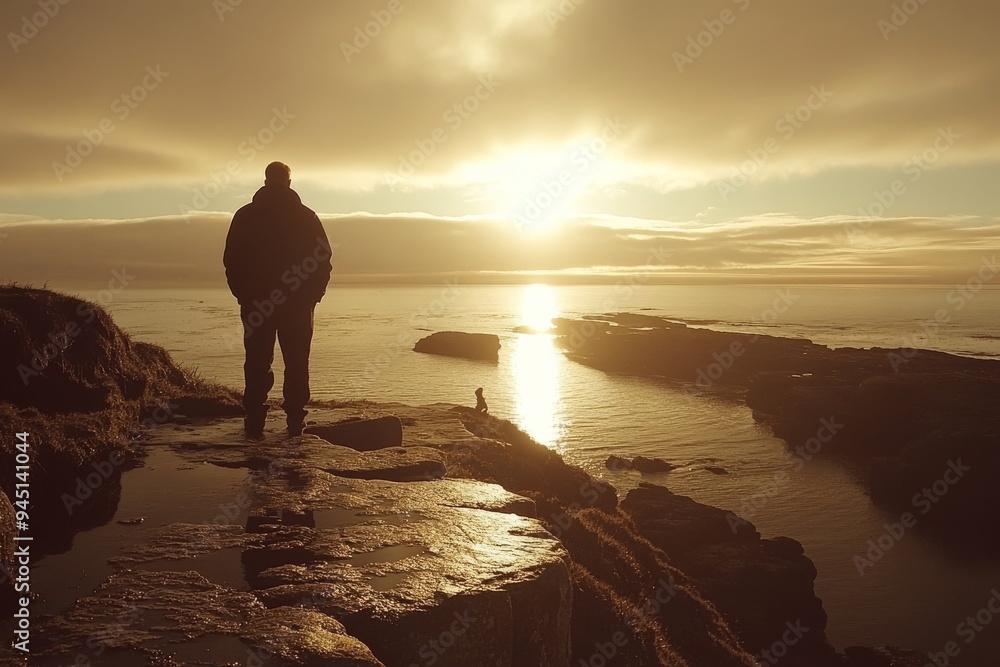 Poster man walking alone on rocky coastal cliff during golden hour contemplating lifes journey and connecti