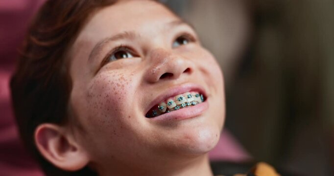 Happy boy, teeth and dentist with braces for tooth treatment, healthcare or cleaning at clinic. Closeup, young child or kid with smile for metal band, dental implant or malocclusion at orthodontist