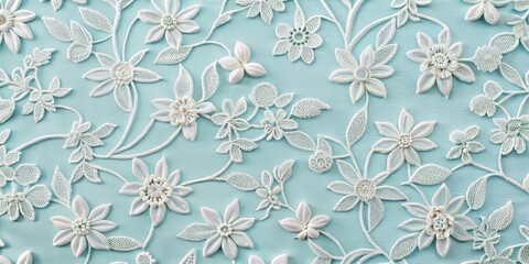 Fototapeta premium Photo image of delicate white cotton fabric with intricate repeating patterns of interlocking flowers and leaves on a soft pastel blue background