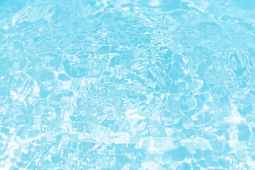 Blue water with ripples on the surface. Defocus blurred transparent blue colored clear calm water surface texture with splashes and bubbles. Water waves with shining pattern texture background.