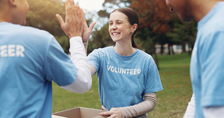High five, volunteer and people in park for charity event, community service and teamwork. Food...
