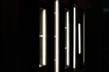 Abstract glowing lights decorate the exterior of an apartment building, creating a vibrant, colorful display that enhances the building's facade