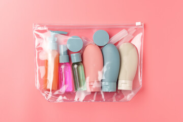 Clear Plastic Bag Containing Travel-Sized Toiletries on Pink Background