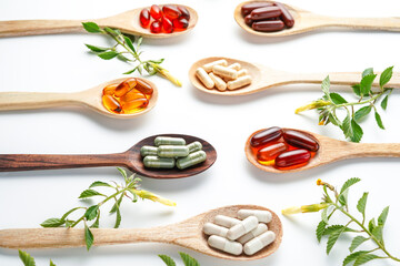 Vitamin capsules in a wooden spoon, soft gels, Fish oil capsules, omega 3, omega 9, vitamin D,...