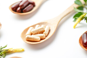 Vitamin capsules in a wooden spoon, soft gels, Fish oil capsules, omega 3, omega 9, vitamin D,...