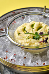 A luxurious and elegant presentation of pike caviar served on ice with a glass of champagne