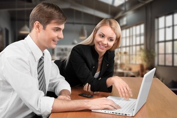 Two busy business colleagues working together