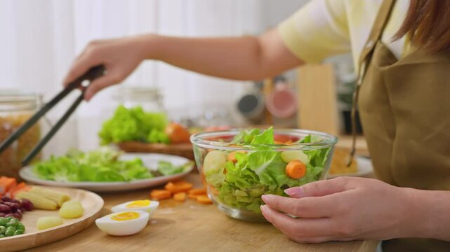 Close up of woman cooking healthy foods in kitchen in morning at home.