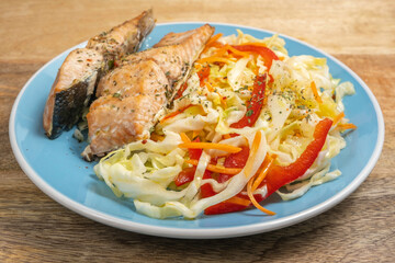 Coleslaw on ceramic plate with grilled salmon