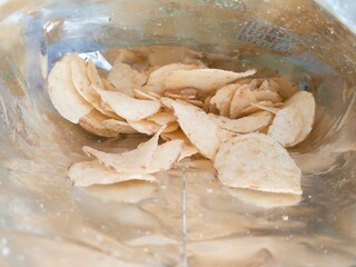 Close-up view of potato chips inside a foil bag