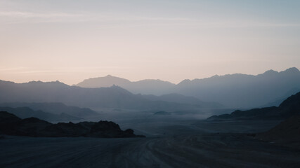 night desert landscape with rocky mountains and sunset sky with clouds in Sharm El Sheikh
