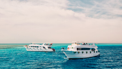 two white cruise tourist boats in the Red Sea in Egypt