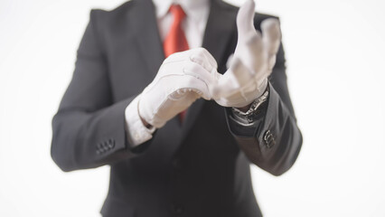 Headless businessman in suit put on white cotton gloves