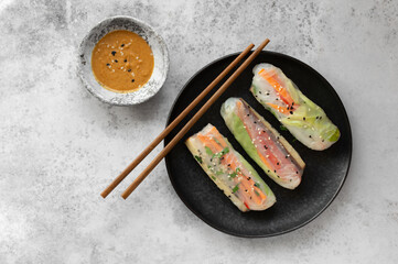 Summer rolls with fresh vegetables and smoked tofu served with peanut sauce and lime. Vietnamese...