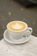 A cup of cappuccino on the table outside