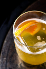 Satsuma cocktail in glass on dark background