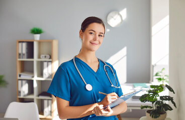 Portrait of happy female nurse or doctor at work. Beautiful young woman clinical nurse or physician...