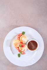 Cottage cheese pancakes, cheesecakes, pancakes with strawberries and jam. Healthy and delicious breakfast. Flat lay. Top view. Copy space. Vertical photo format.