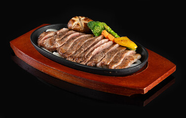 Modern style traditional Commonwealth Sunday roast with sliced cold cuts roast beef with tomatoes and scallions as top view in a design plate