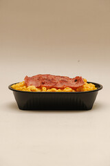 Mac and cheese tasty Italian pasta with Cheddar cheese on plain background