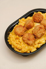 Mac and cheese tasty Italian pasta with Cheddar cheese on plain background