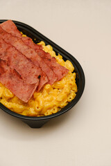 Mac and cheese tasty Italian pasta with Cheddar cheese on plain background