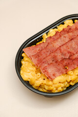 Mac and cheese tasty Italian pasta with Cheddar cheese on plain background