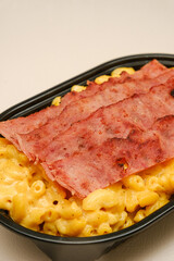 Mac and cheese tasty Italian pasta with Cheddar cheese on plain background
