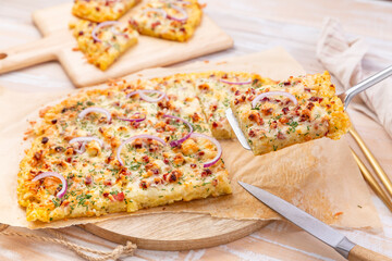 Homemade potato tarte flambee, savory flam cake with onion, bacon, cheese and potatoes