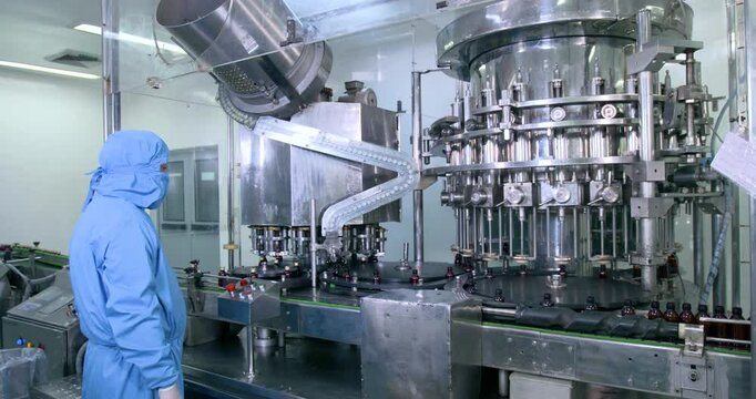 pharmaceutical medicine liquid filling machine in bottles, syrup sanitiser gel filling in bottle production line filling making process in a plastic transparent bottle manufacturing factory	
