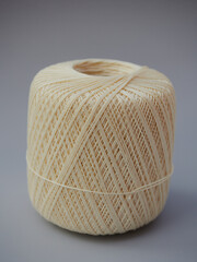 Green knitting balls in a basket with knitting needles on gray background. Set for the hobby of knitting warm clothes or toys. Concept needlework