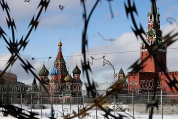 Censorship and government control in Russia. St. Basil's Cathedral and the Kremlin tower seen through a barbed wire. Security perimeter on the Red Square, Moscow. Autocracy in Russian Federation