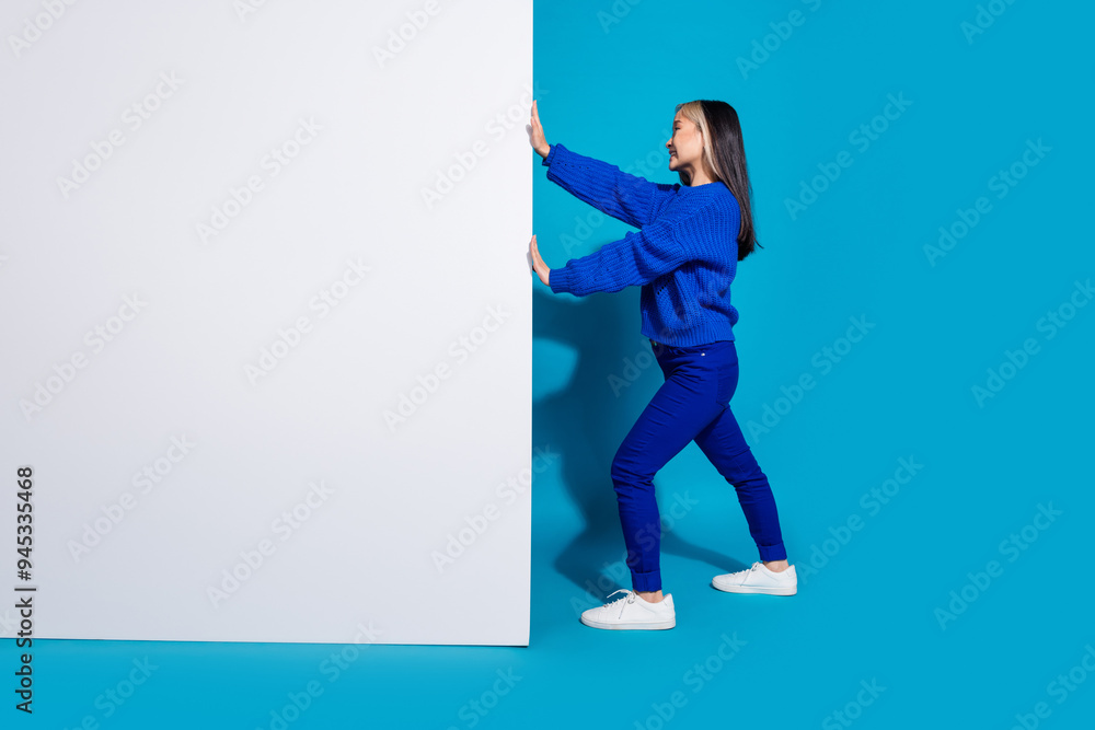 Sticker photo portrait of trendy chinese saleswoman pushing billboard wall empty blank space advertisement i