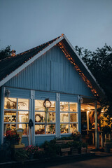 Cozy blue house with a beautiful garden on a evening. Rustic style. House in the country. English...