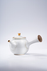 Traditional Chinese teapot and teacup on white background, tea ceremony utensils