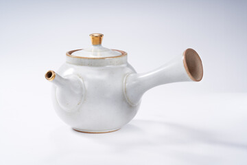 Traditional Chinese teapot and teacup on white background, tea ceremony utensils
