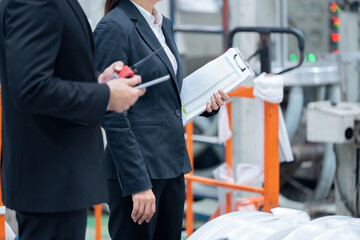 A close-up half-body photo of male and female engineers working together to explore new technologies to solve complex problems in industrial machinery, resulting in a successful project.