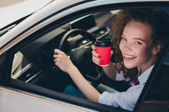 Photo of shiny attractive lady driver dressed white shirt smiling riding car enjoy coffee outdoors urban city street