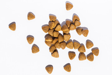 food for dogs and cats in the form of small triangles scattered on a white background