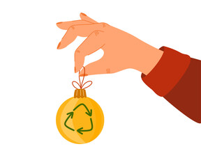 Green Christmas concept. Vector eco-friendly sustainable illustration. The human hand holds a green Xmas toy with a recycling symbol.