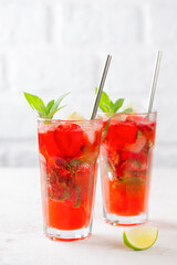 Fresh cocktail with strawberries, mint and lime. Strawberry mojito. Refreshing red drink, sugar free. Vertical orientation.